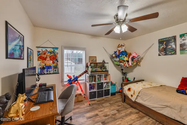 a bathroom with a granite countertop sink and a toilet