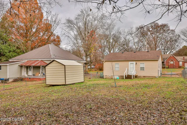 a backyard of a house with large trees