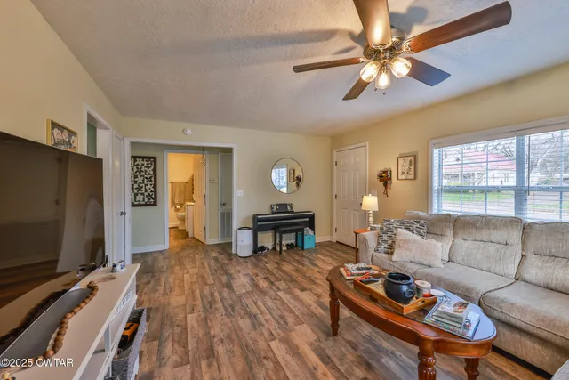 a kitchen with stainless steel appliances a sink window and cabinets