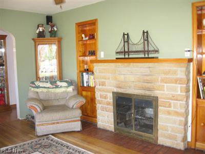45500 Telegraph Road Elyria, OH 44035 - Photo 12 of 25 Living Room has hardwood floors, built in cabinets and a fireplace.