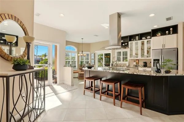 a very nice looking dining room with a large window and kitchen view