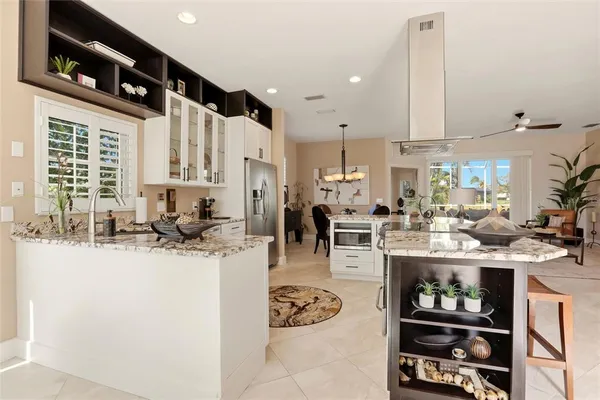 a kitchen with stainless steel appliances kitchen island granite countertop a sink and cabinets