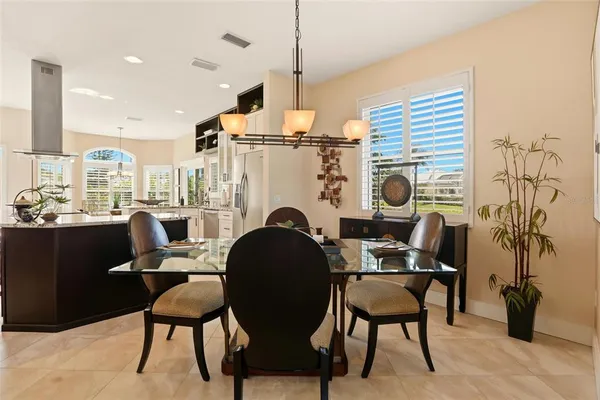 a work room with furniture a large window and wooden floor