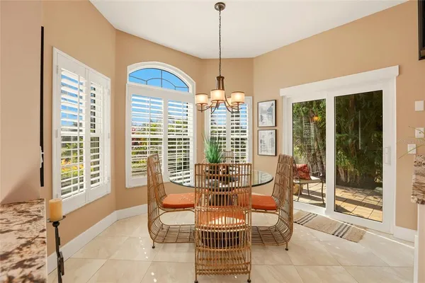 a dining room with furniture and large windows