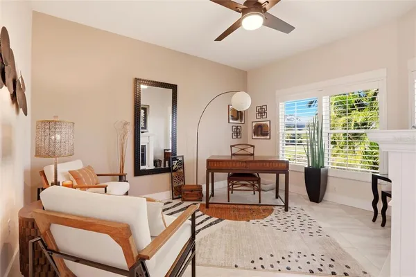 a living room with furniture a rug and white walls