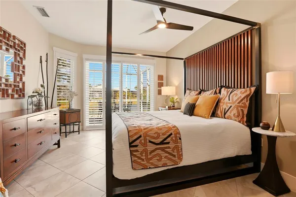 a bedroom with furniture and large window