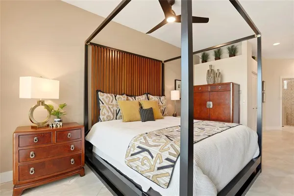 a bedroom with a bed and a mirror on the dresser
