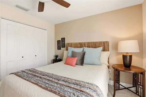 a bedroom with a bed and a lamp on table