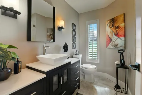 a bathroom with a sink toilet and mirror