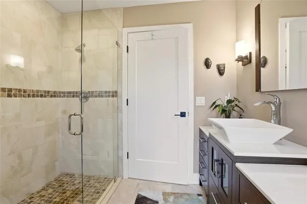 a bathroom with a shower and a sink