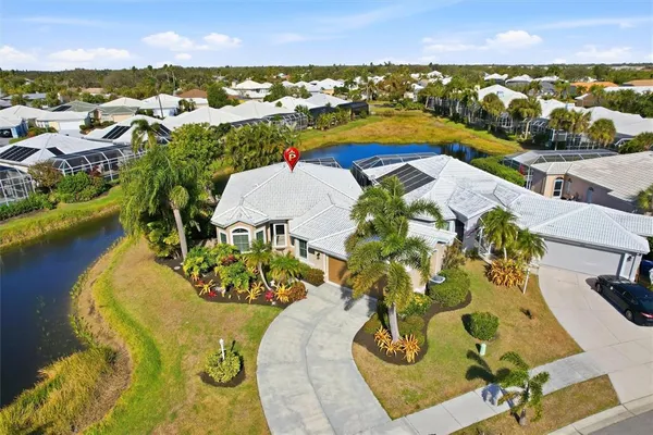 an aerial view of residential houses with outdoor space and swimming pool