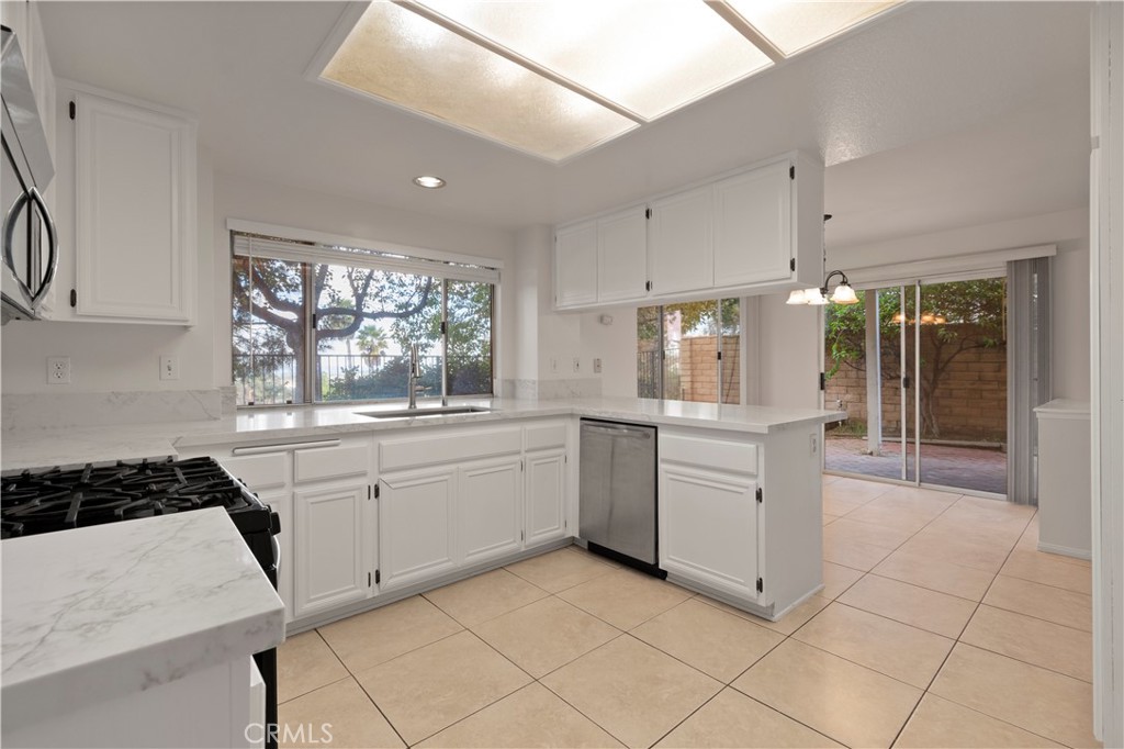 14 La Ramada Place Phillips Ranch, CA 91766 - Photo 26 of 61 a kitchen with cabinets and window