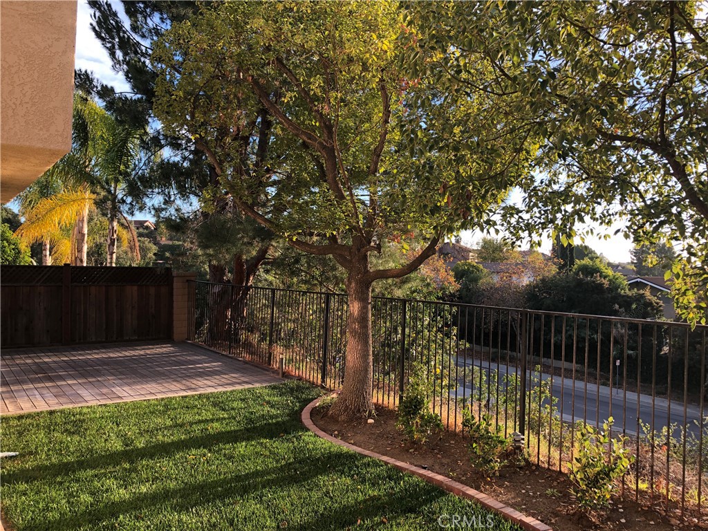 14 La Ramada Place Phillips Ranch, CA 91766 - Photo 56 of 61 a view of backyard with wooden fence and large trees