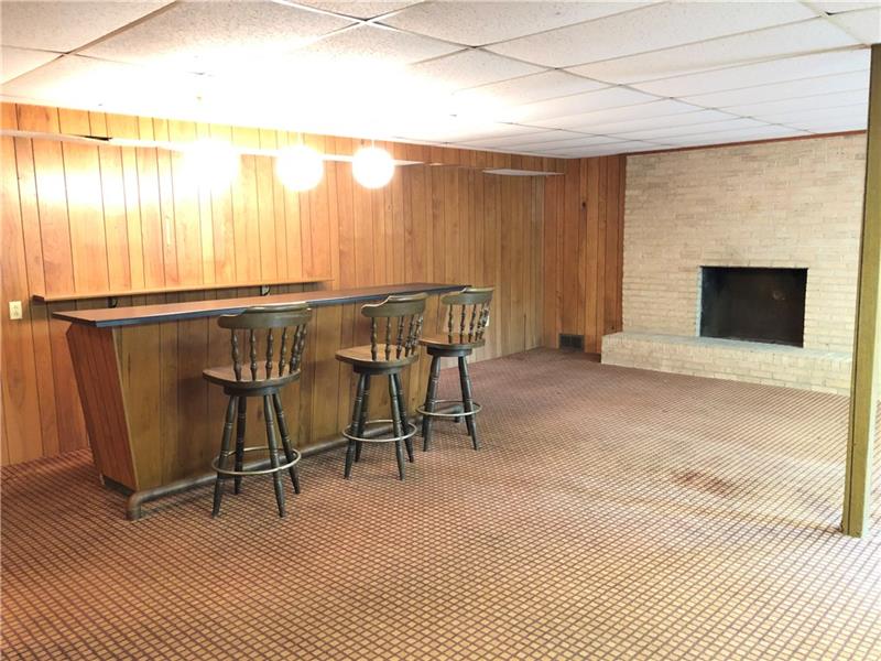 159 Hilton Road Greensburg, PA 15601 - Photo 12 of 22 Wet bar, fireplace, lots of room for all the family fun times.
