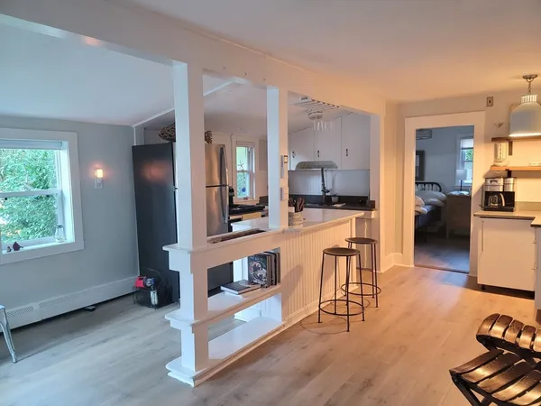 a kitchen with stainless steel appliances kitchen island granite countertop a stove and a sink