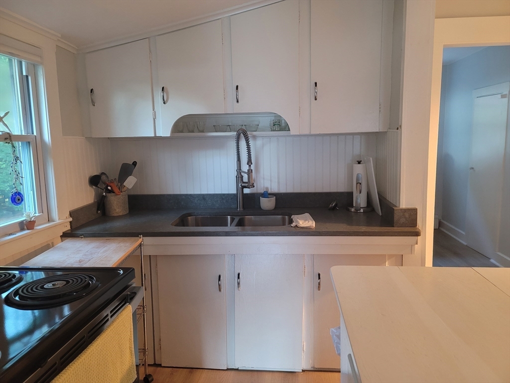 24 Pattison Avenue Dudley, MA 01571 - Photo 3 of 9 a kitchen with a stove and a refrigerator