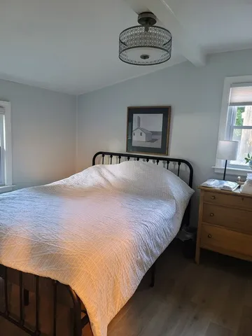 a bedroom with bed and a chandelier