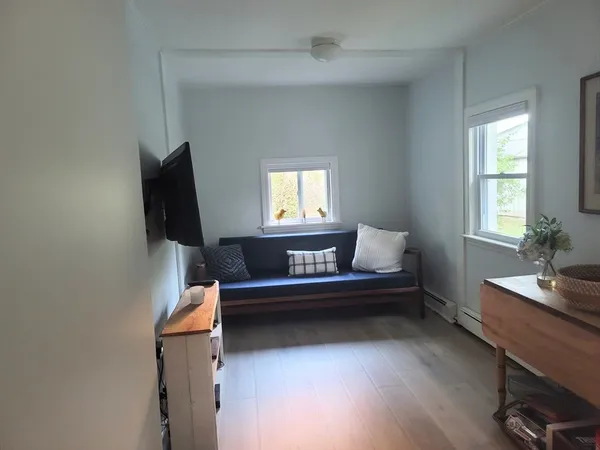 a view of a workspace with furniture and a window