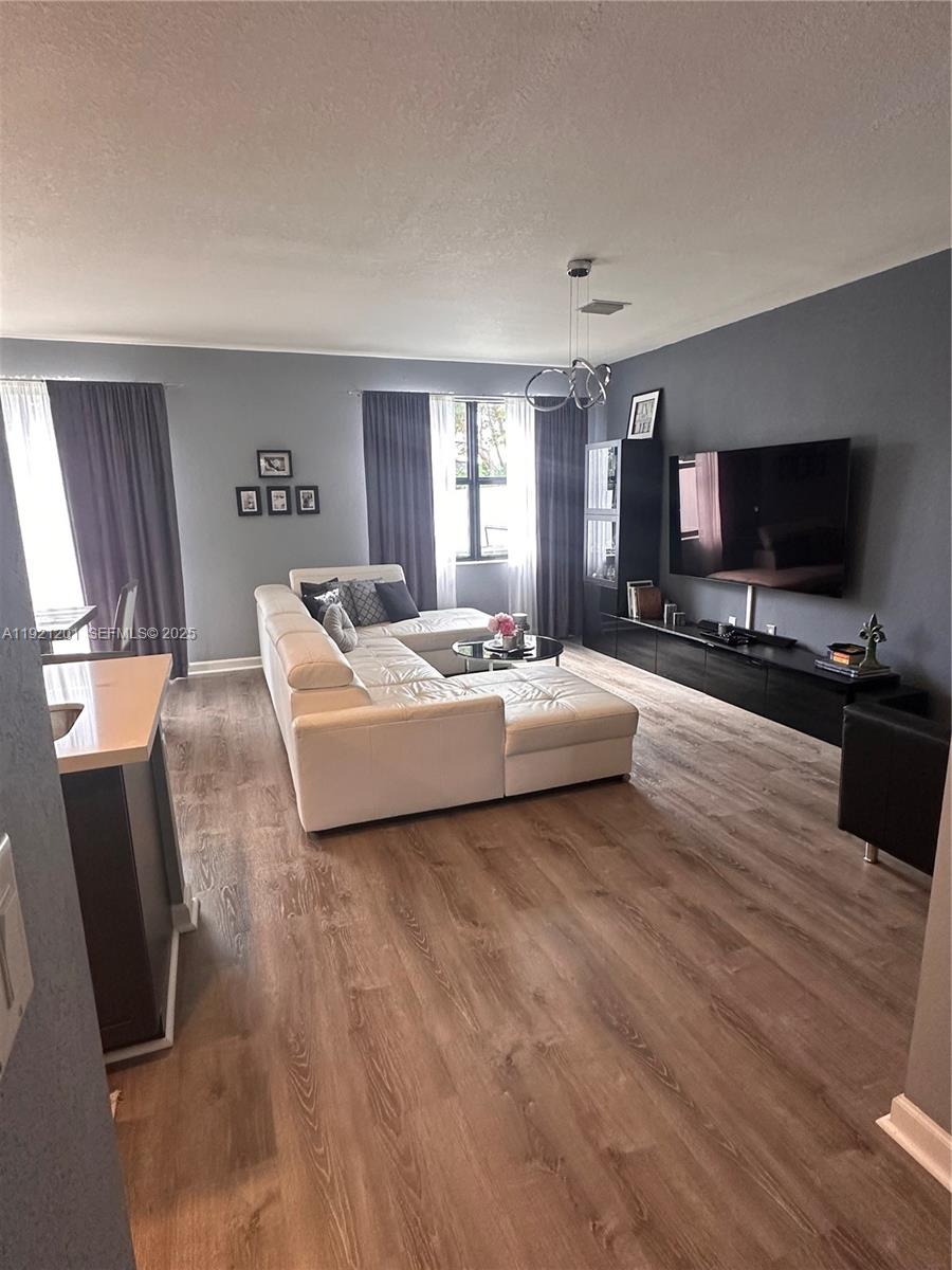 3378 West 100th Terrace, Unit 3378 Hialeah, FL 33018 - Photo 11 of 41 a living room with furniture and a flat screen tv