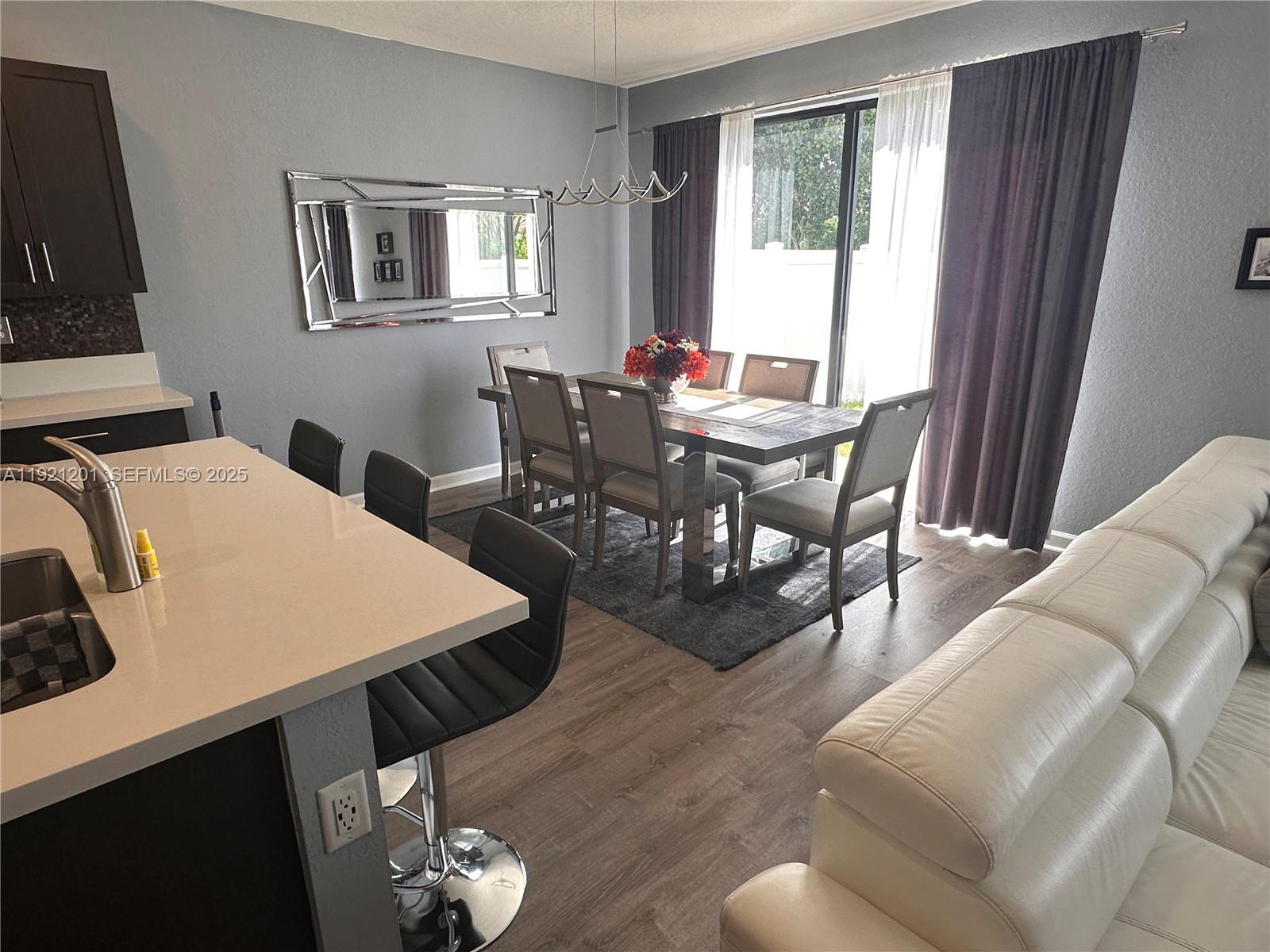3378 West 100th Terrace, Unit 3378 Hialeah, FL 33018 - Photo 17 of 41 a view of a dining room with furniture and window
