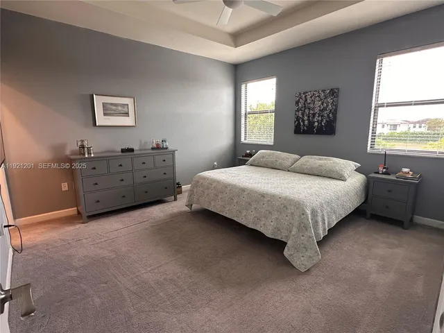 a bedroom with a bed dresser and a window