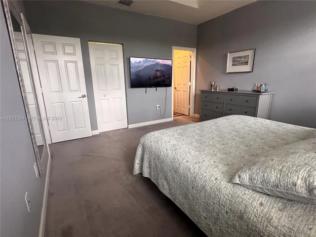 a bedroom with a bed and a mirror