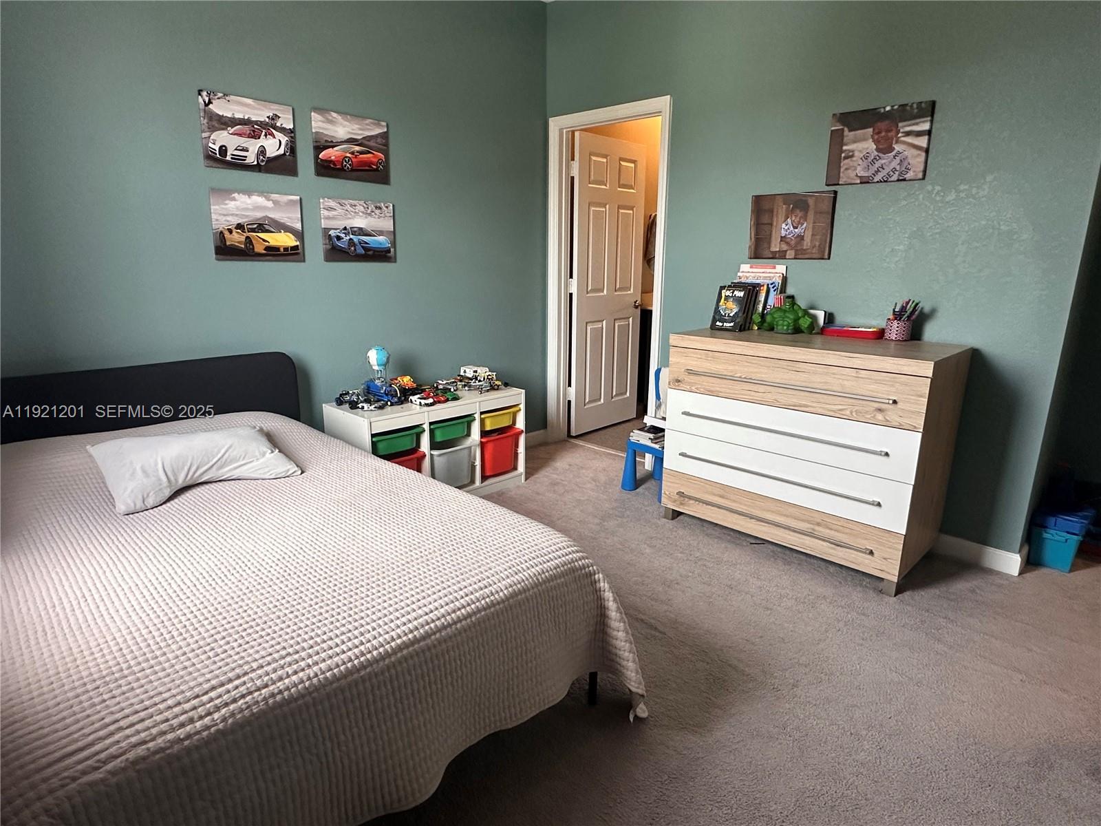 3378 West 100th Terrace, Unit 3378 Hialeah, FL 33018 - Photo 27 of 41 a bedroom with a bed and a chair