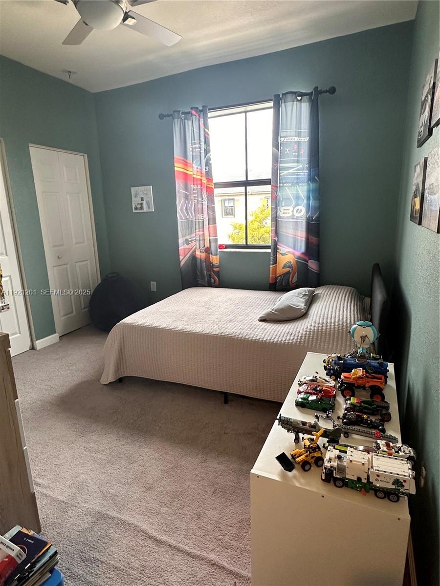 3378 West 100th Terrace, Unit 3378 Hialeah, FL 33018 - Photo 28 of 41 a bedroom with a bed and a dresser