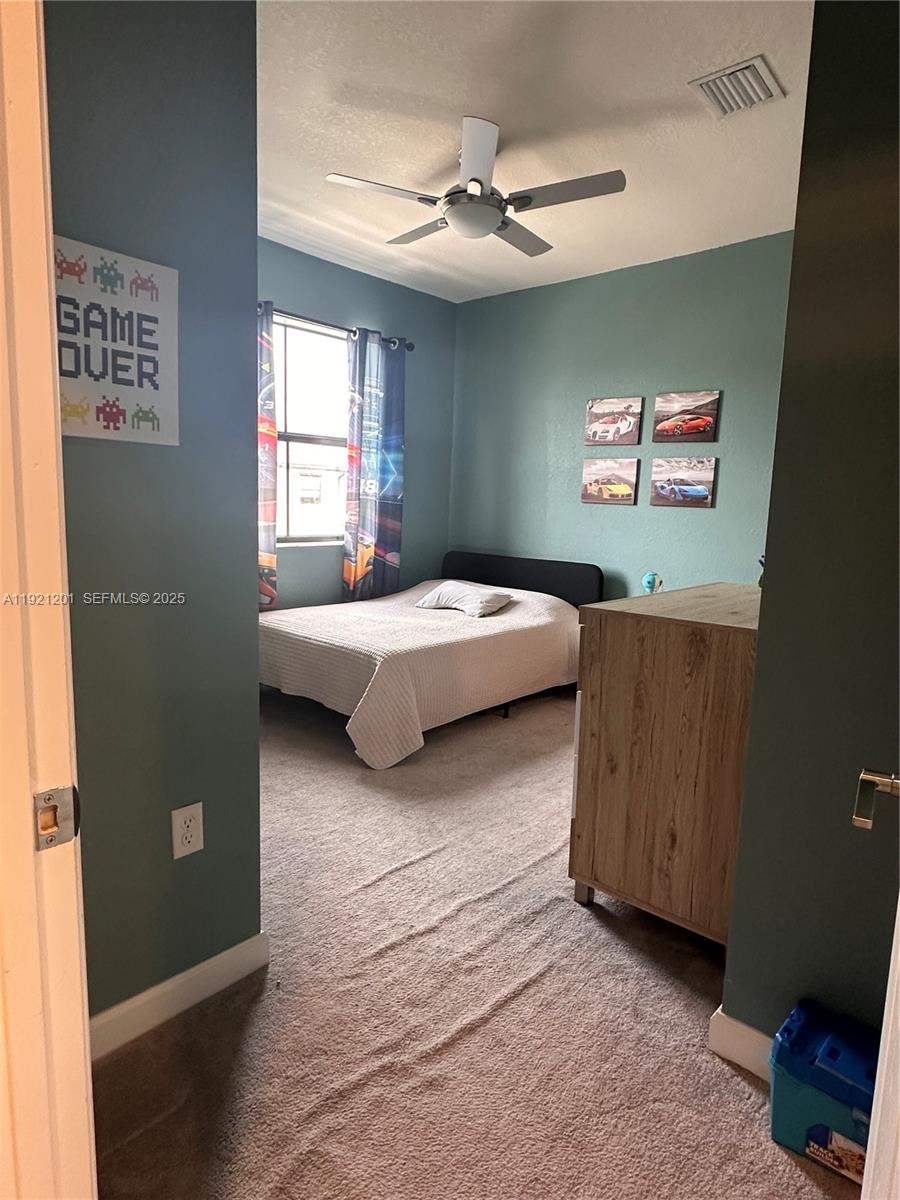 3378 West 100th Terrace, Unit 3378 Hialeah, FL 33018 - Photo 29 of 41 a bedroom with a bed and a window