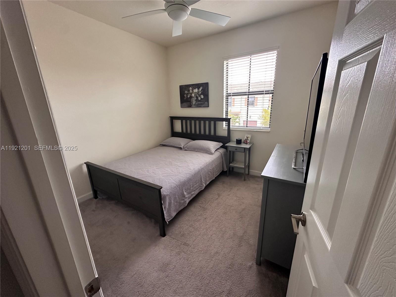 3378 West 100th Terrace, Unit 3378 Hialeah, FL 33018 - Photo 33 of 41 a bedroom with a bed and a large window
