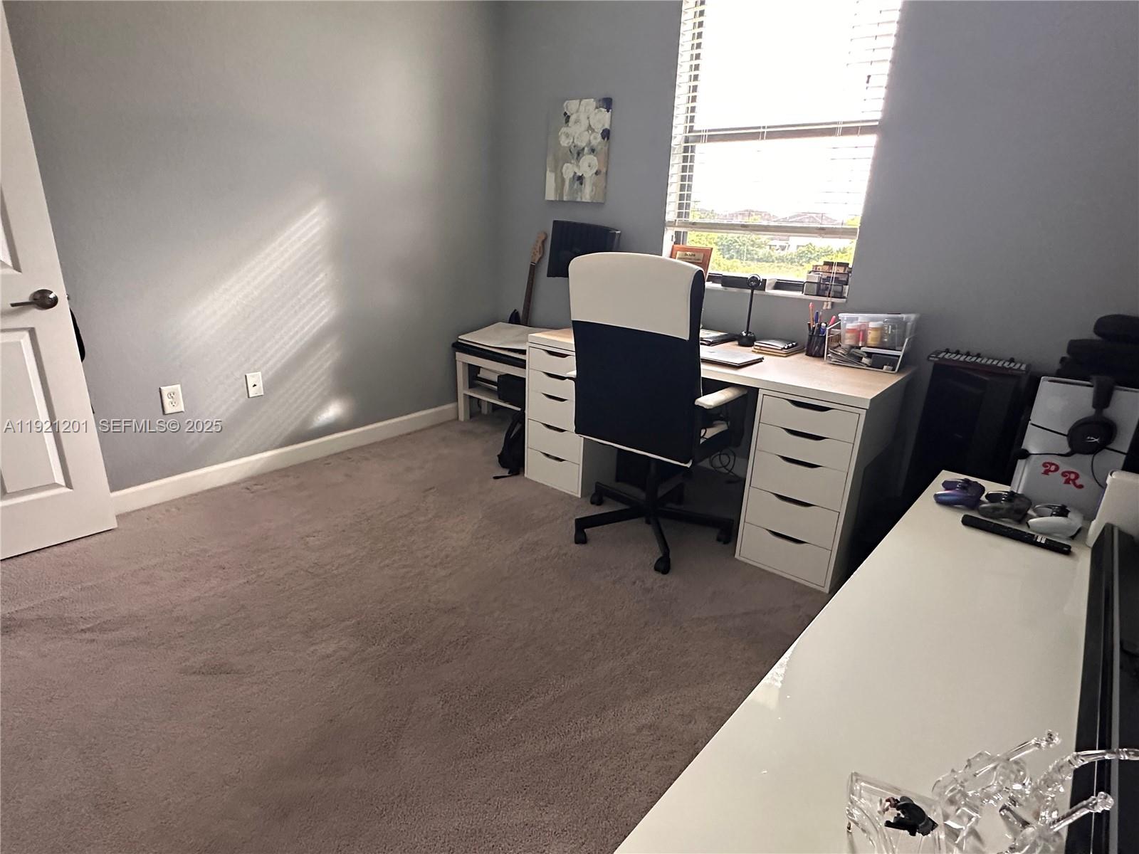 3378 West 100th Terrace, Unit 3378 Hialeah, FL 33018 - Photo 35 of 41 a view of a workspace with furniture and a window