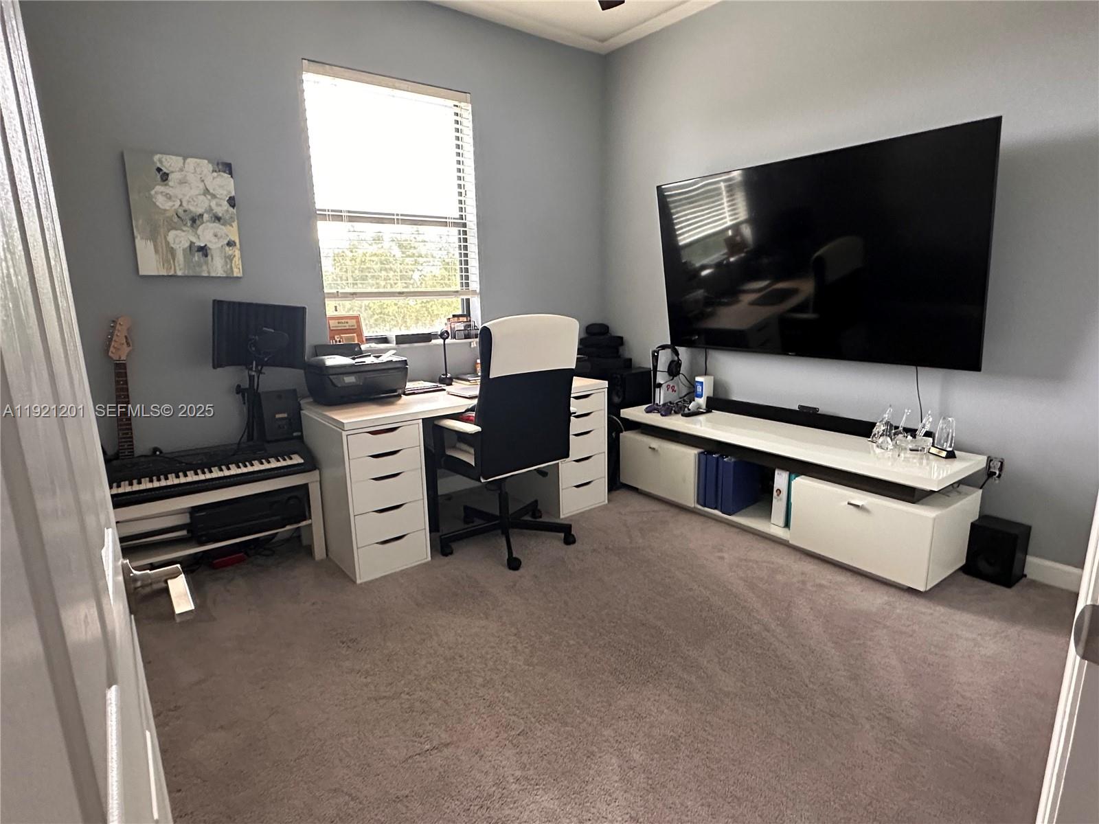 3378 West 100th Terrace, Unit 3378 Hialeah, FL 33018 - Photo 36 of 41 a living room with furniture and a flat screen tv