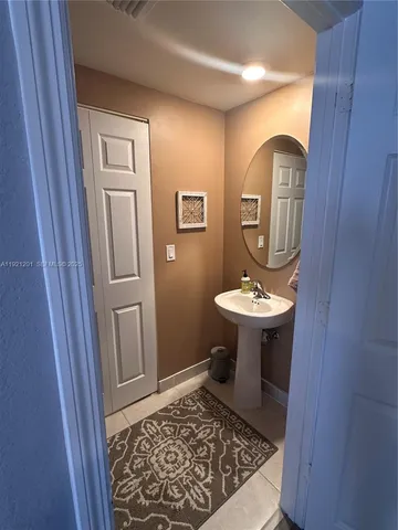 a bathroom with a sink a mirror and a toilet