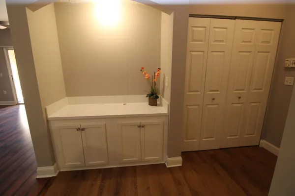 a view of a kitchen with wooden floor and a window