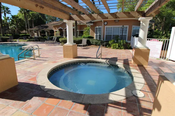 a living room with furniture a large window and a fireplace