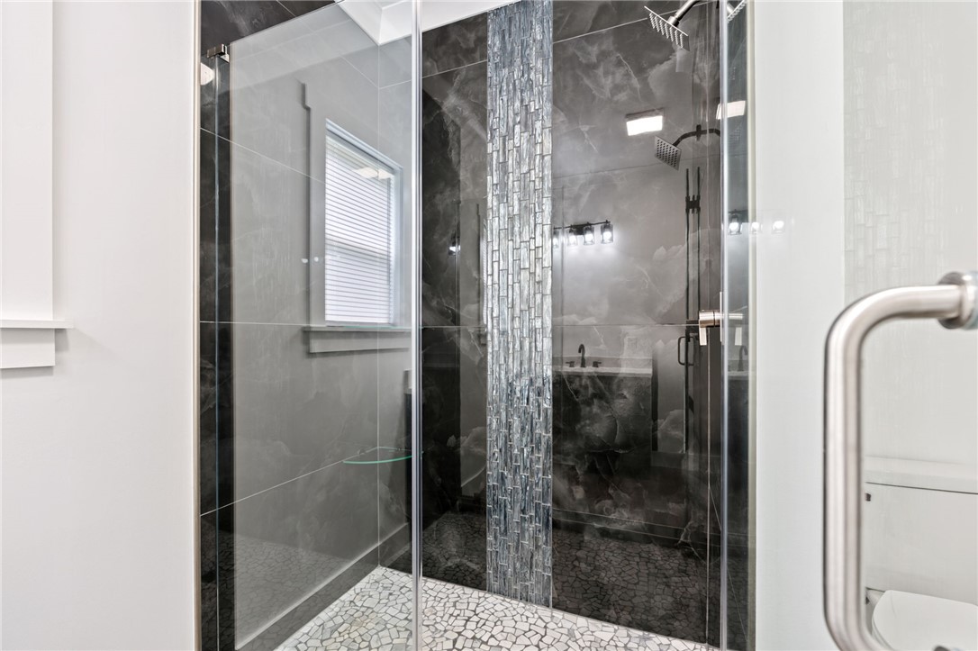914 Smith Grove Road Easley, SC 29640 - Photo 20 of 37 A well-appointed shower space showcases contemporary tile work and dual shower heads.