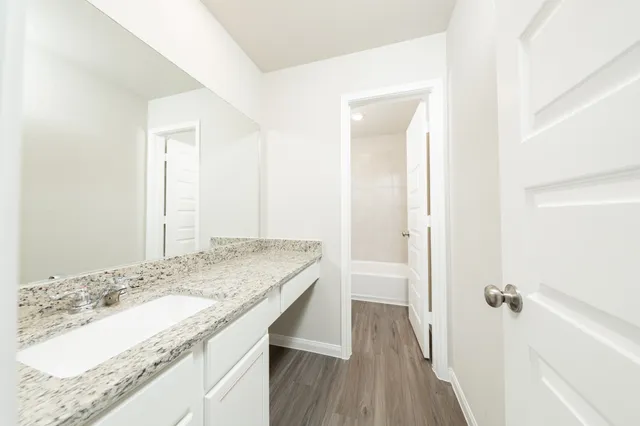 a bathroom with a granite countertop sink