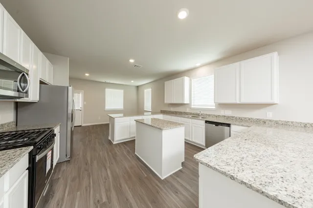 a kitchen with a sink stove and cabinets