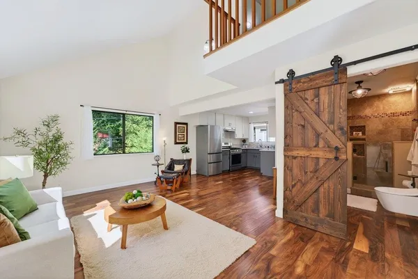 a living room with furniture and a wooden floor