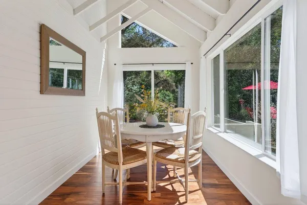 a view of a dining room with furniture window and wooden floor