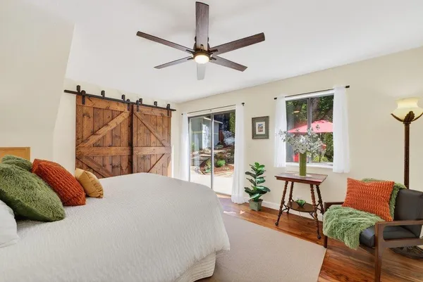 a bedroom with a bed and wooden floor