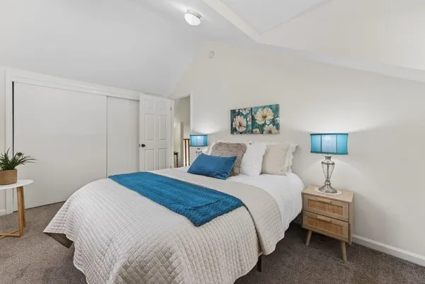 a bedroom with a bed and a lamp