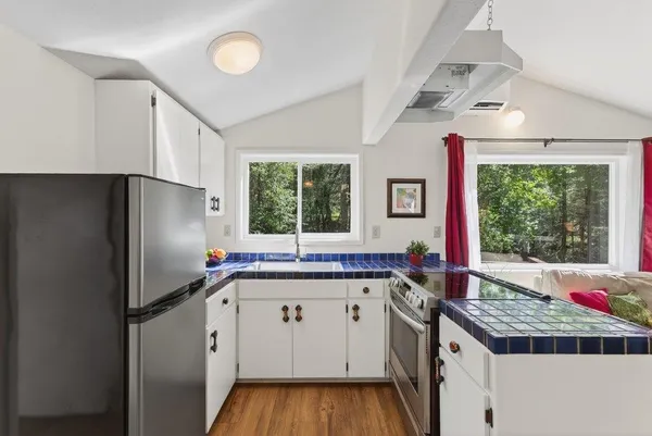 a kitchen with a sink stove and refrigerator
