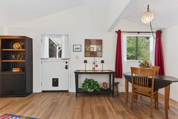 a view of a livingroom with furniture wooden floor and windows