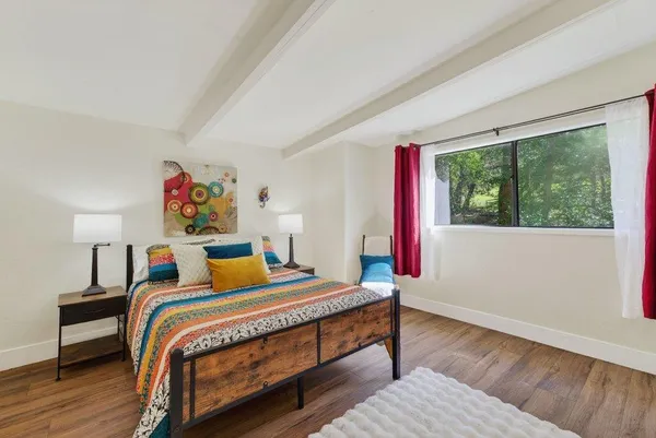 a bedroom with a bed and a large window