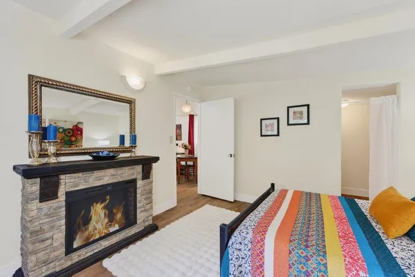 a bedroom with a bed and a fireplace