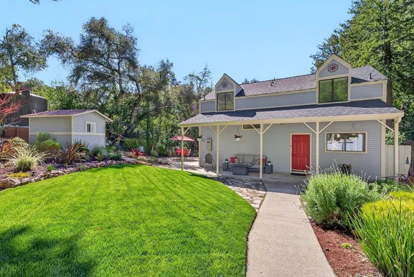 a front view of house with yard and green space