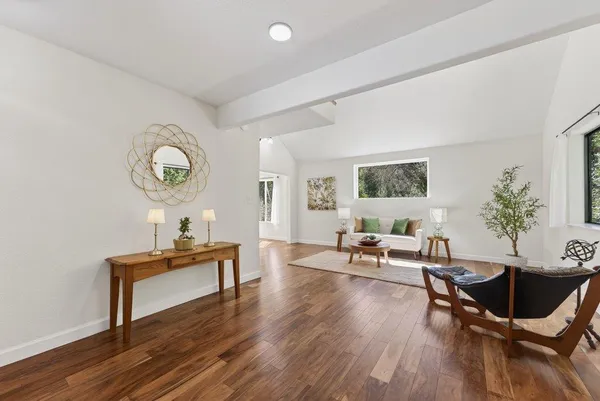 a living room with furniture and wooden floor