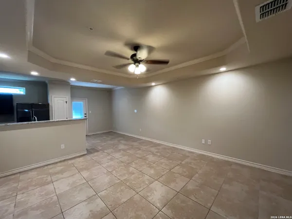 an empty room with fan and fan