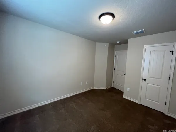 an empty room with a empty space and windows